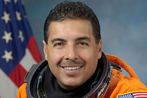 a headshot of jose hernandez in his astronaut uniform
